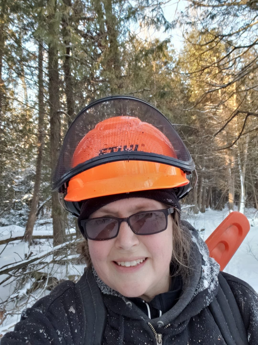 Janet wearing safety gear while working outdoors